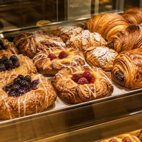 Fruit danishes and croissants in a display case (sample image)