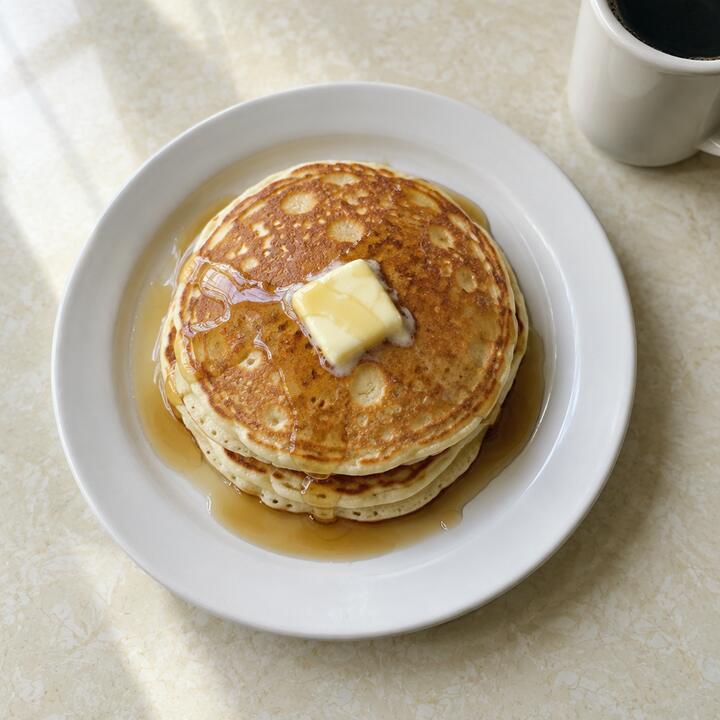 A buttermilk short stack with butter and syrup (AI sample photo)
